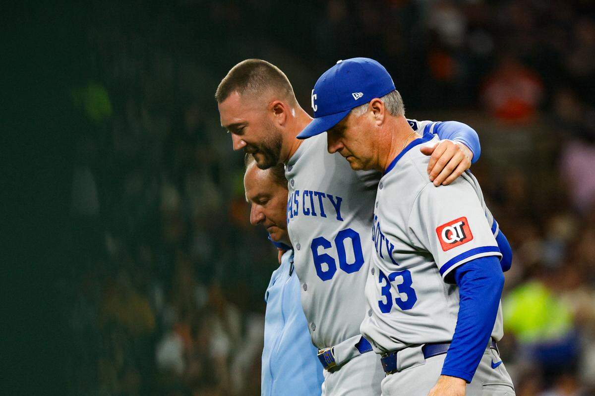 Kansas City Royals pitcher Lucas Erceg (60) is helped off the field by manager Matt Quatraro (33) and training staff during the seventh inning against the Detroit Tigers at Comerica Park on April 18, 2025.