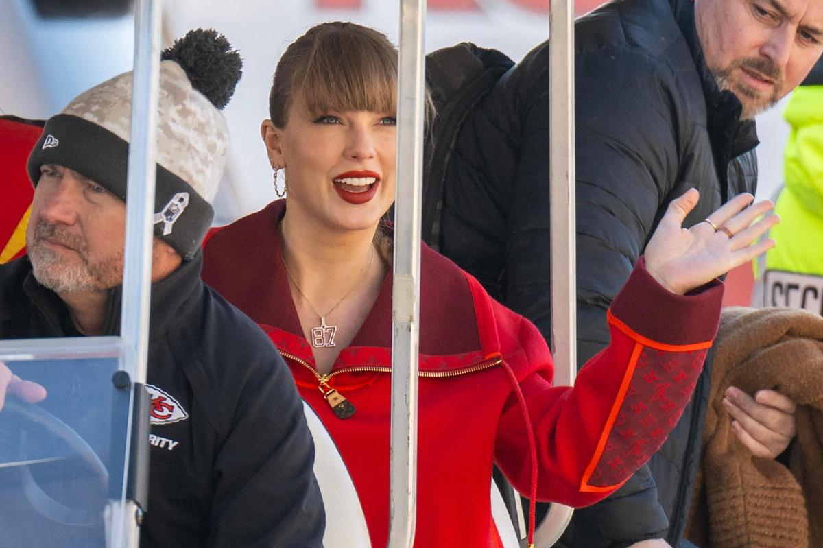 Pop star Taylor Swift smiles and waves to fans as she is driven through a tunnel on a golf cart to attend an NFL game between the Kansas City and the Las Vegas Raiders on Friday, Nov. 29, 2024, at GEHA Field at Arrowhead Stadium.