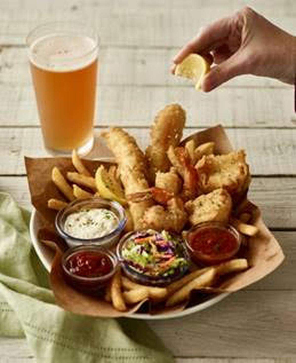 Bonefish Grill’s Angler’s Catch (tempura-battered cod, shrimp and scallops on a bed of French fries with coleslaw, for $17.90).