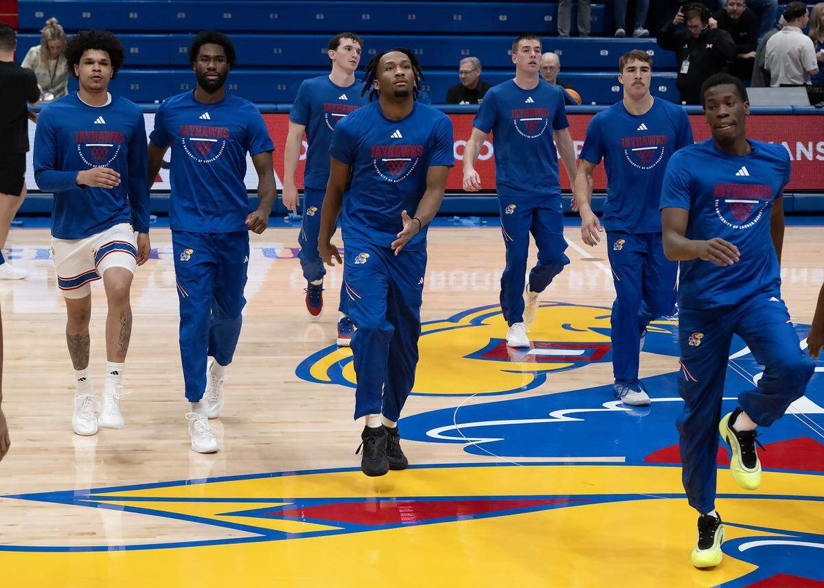 Kansas Jayhawks guard Darryn Peterson (22), center, and other players warm up at Allen Fieldhouse before the game against the Iowa State Cyclones on Tuesday, Jan. 13, 2026, in Lawrence, Kansas
