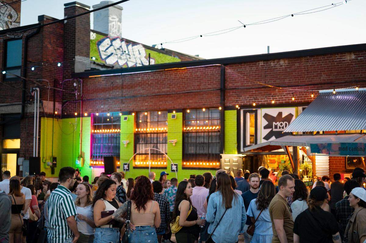 People line up at Mod Cantina during the First Fridays celebration in Kansas City’s Crossroads Art District on June 3, 2022.