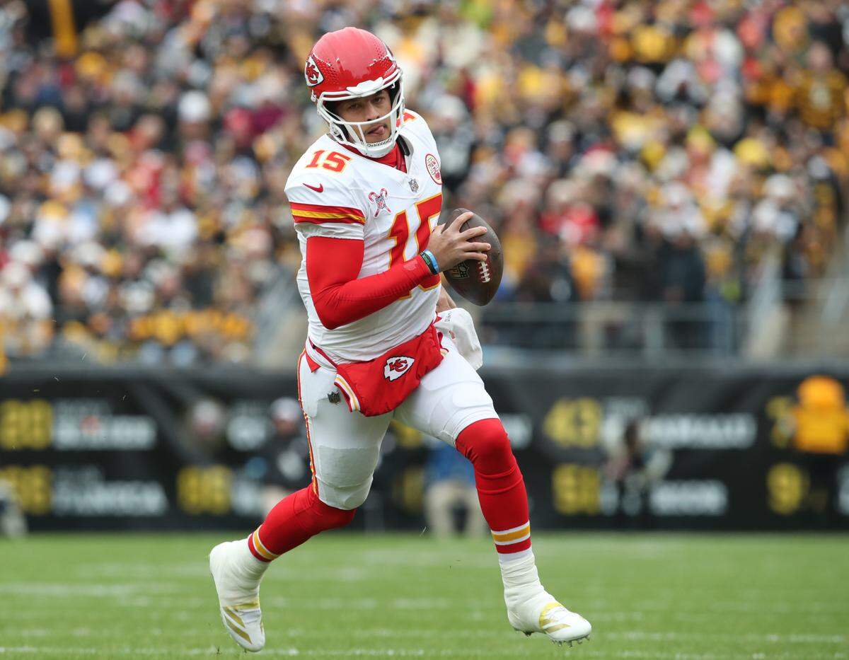Kansas City Chiefs quarterback Patrick Mahomes rolls out of the pocket during an NFL Week 17 game against the Steelers at Acrisure Stadium in Pittsburgh, Pennsylvania on Wednesday, Dec 25, 2024.