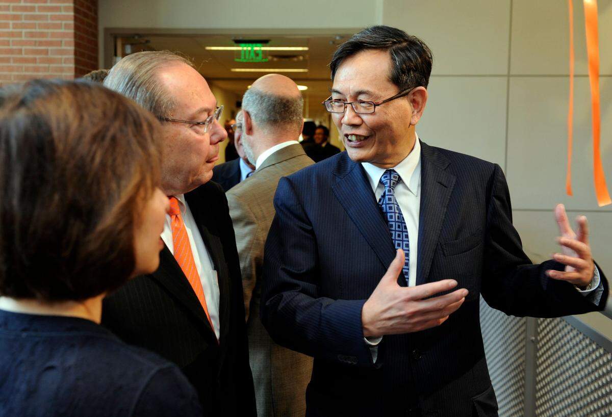Min H. Kao, right, and his wife, Fan, left, talk to Chancellor Jimmy Cheek following the ribbon cutting ceremony at the dedication of the new Min Kao Electrcial Engineering and Computer Science Building Wednesday, Mar. 14, 2012.  The Min H. Kao building on Middle Drive is located on the corner of 11th Street and Cumberland Avenue.    (MICHAEL PATRICK/NEWS SENTINEL)0315 Kclo Minkao01 Mp