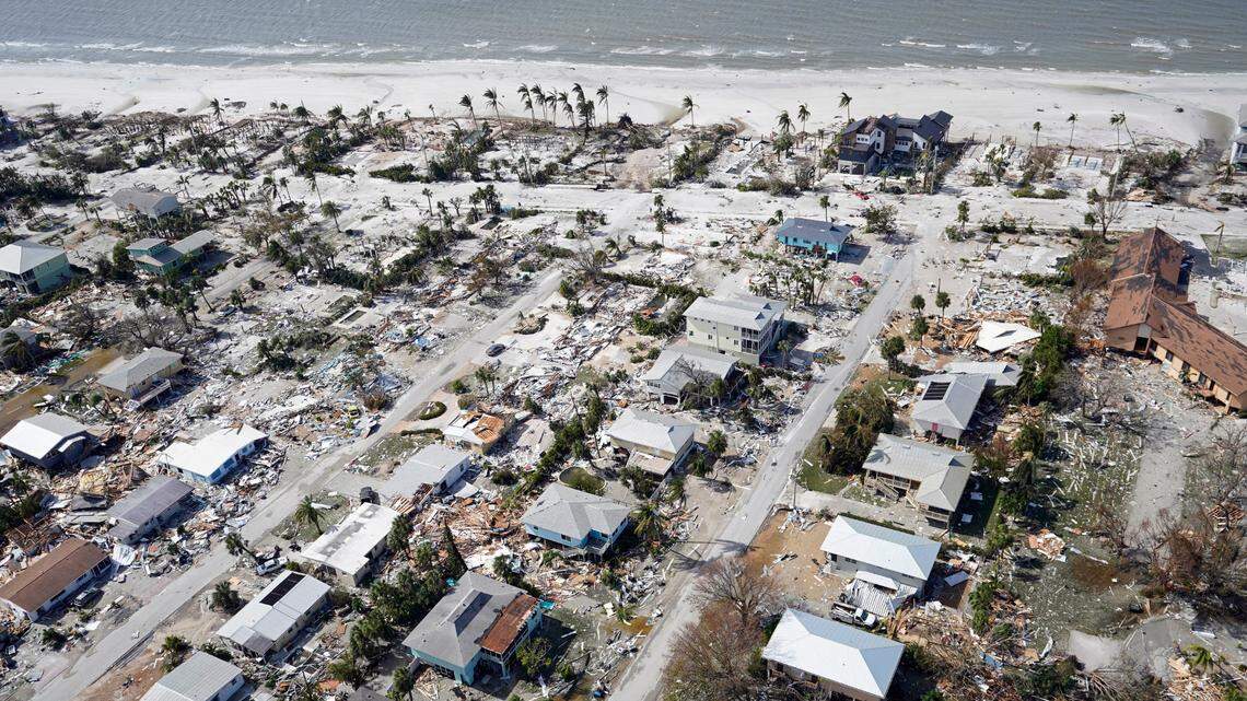 This aerial photo shows damaged homes and debris in the aftermath of Hurricane Ian, Thursday, Sept. 29, 2022, in Fort Myers Beach, Fla.