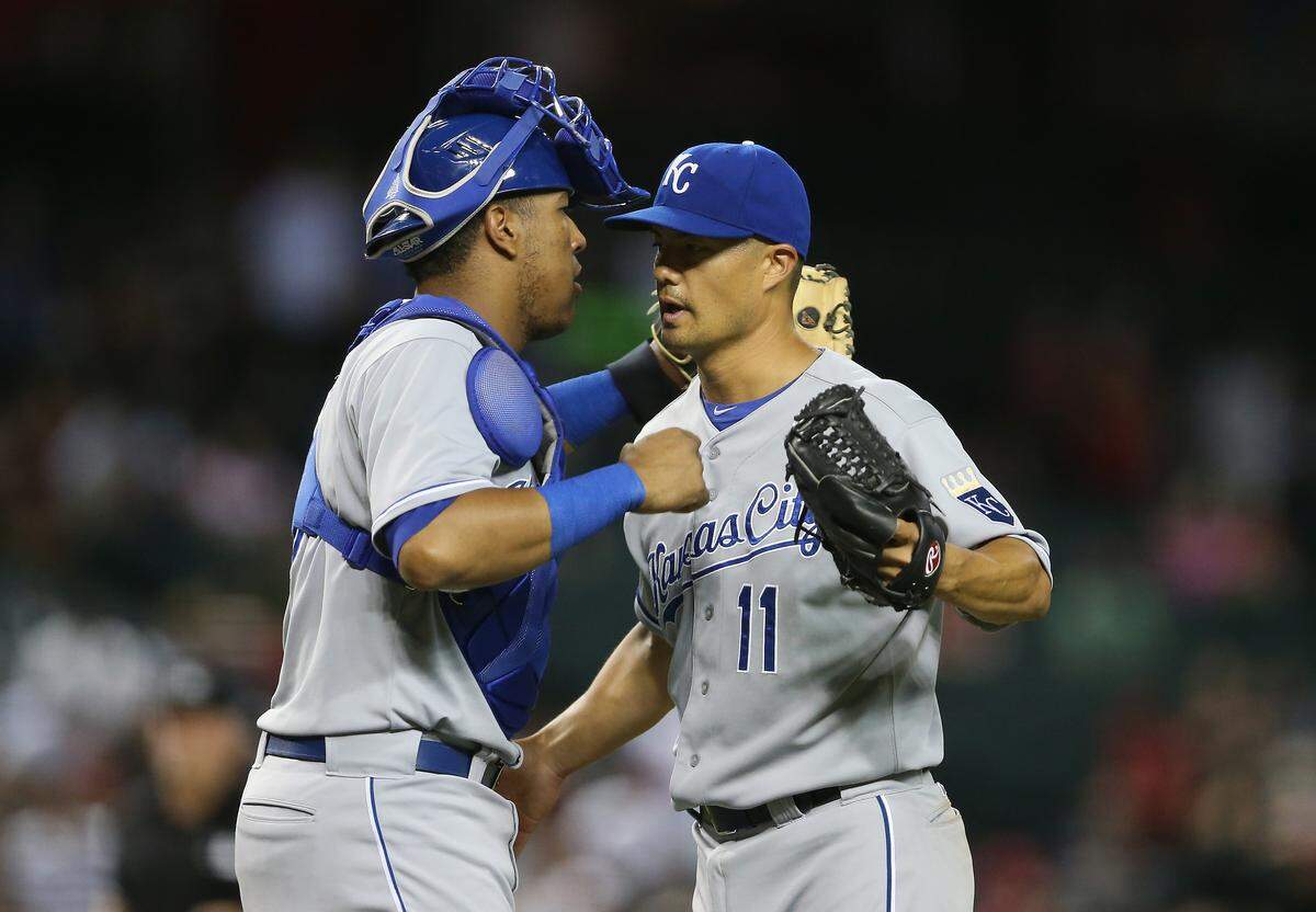 Starting pitcher Jeremy Guthrie #11 of the Kansas City Royals celebrates with catcher Salvador Perez #13 after defeating the Arizona Diamondbacks 6-2 in the MLB game at Chase Field on August 7, 2014 in Phoenix, Arizona.