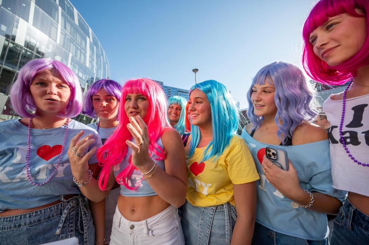 Katy Perry fans wear colorful wigs and matching T-shirts that say “I love Katy” while waiting in line for Perry’s Lifetimes Tour at the T-Mobile Center on Saturday, May 10, 2025, in Kansas City.