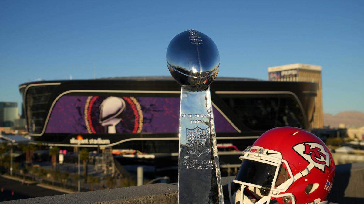 A Kansas City Chiefs helmet and Super Bowl Vince Lombardi Trophy at Allegiant Stadium.
