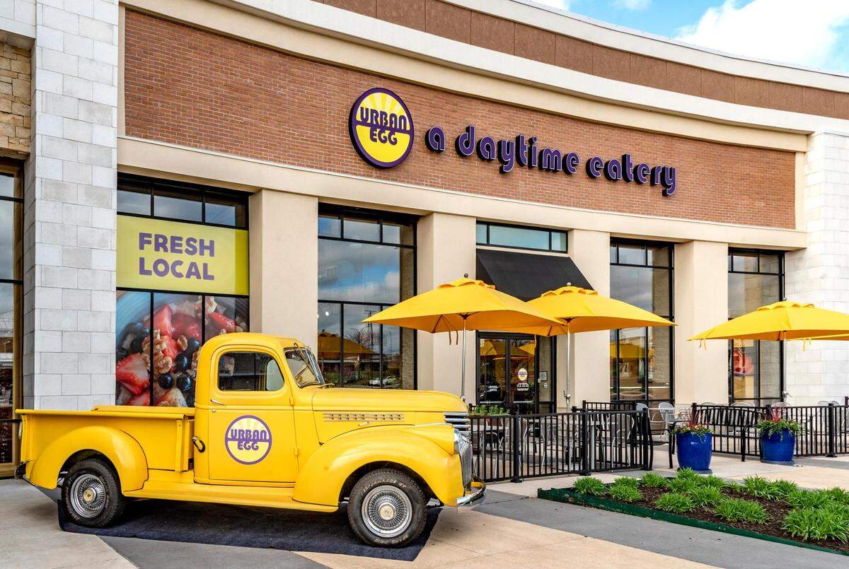 The chain’s 1942 bright yellow Chevy truck is parked outside during the opening in April 2022 of the new Urban Egg restaurant, located in Hawthorne Plaza, 4921 W. 119th St., in Overland Park.