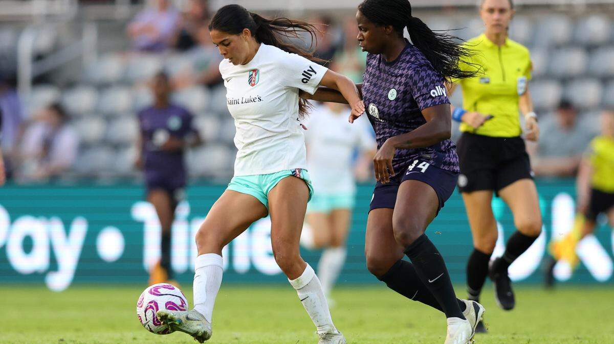KC Current midfielder Chardonnay Curran tries to fend off Racing Louisville defender Satara Murray, right, during Wednesday evening’s NWSL Challenge Cup game at Lynn Family Stadium.