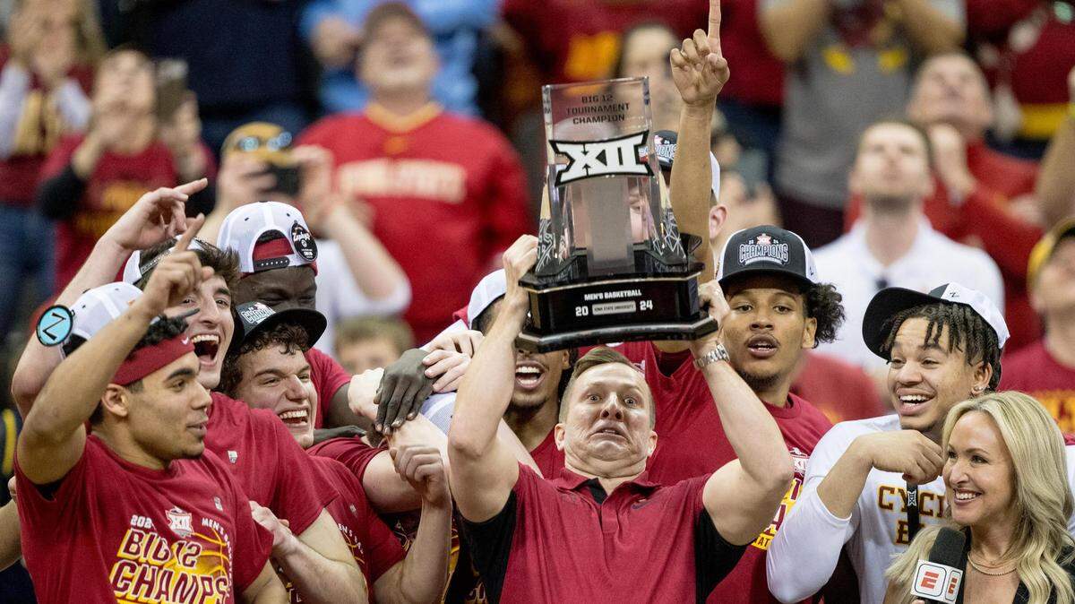 Iowa State Cyclones head coach T. J. Otzelberger hoists the Big 12 championship trophy after defeating the Houston Cougars in the Big 12 men’s basketball tournament championship game on Saturday, March 16, 2024, in Kansas City.