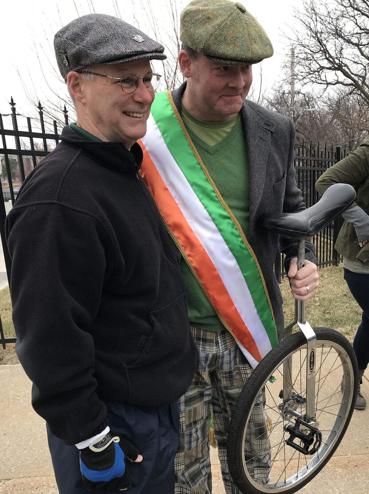 Comedian and actor David Koechner poses with a unicyclist before he took the role of grand marshal of the Kansas City St. Patrick's Day parade.