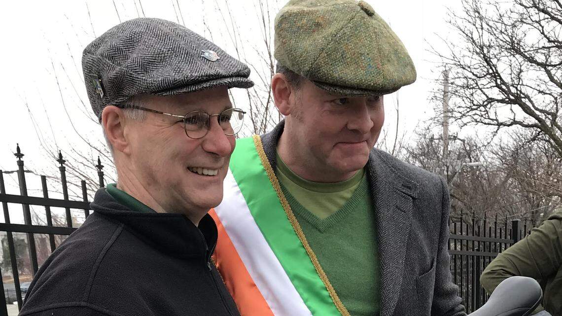 Comedian and actor David Koechner poses with a unicyclist before he took the role of grand marshal of the Kansas City St. Patrick's Day parade.