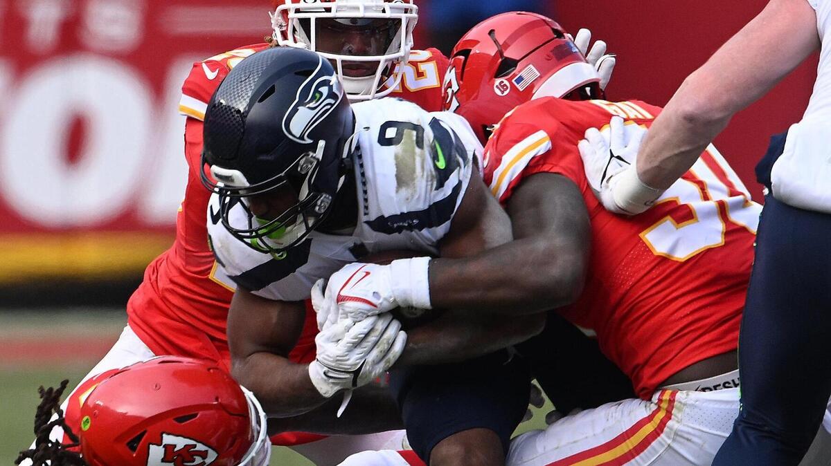 KC’s Nick Bolton, Justin Reid and Willie Gay wrap up Seattle running back Kenneth Walker during the second half of Saturday’s game at Arrowhead Stadium.