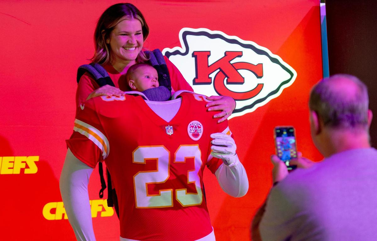 Ashley Bermeo of Tempe, Ariz., poses for a photo with her 3-month-old son Caden at the NFL’s Super Bowl Experience on Thursday, Feb. 9, 2023, in Phoenix.