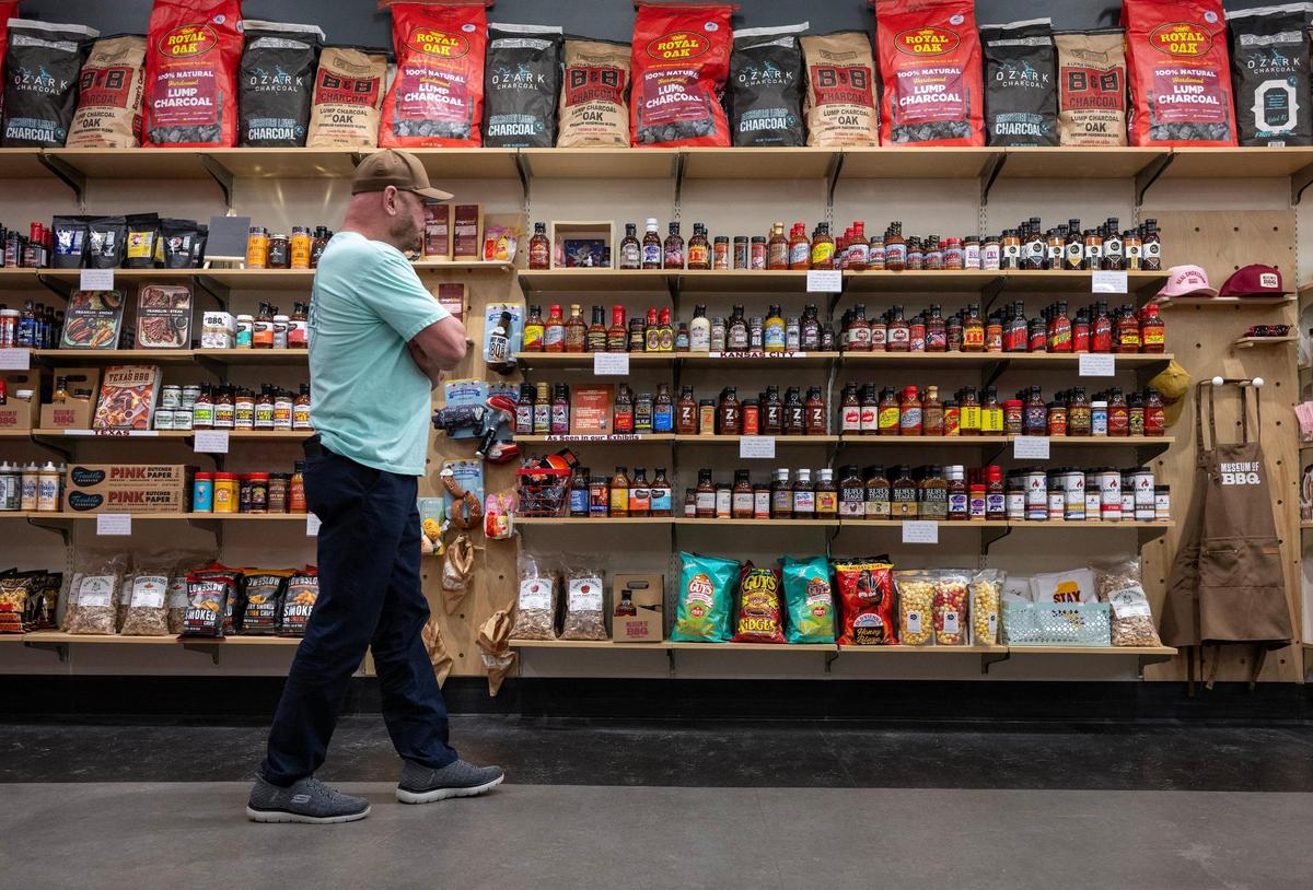 David Gist, a visitor from Mississippi, takes a closer look at the various bottles of barbecue sauce offered in the gift shop of the new Museum of BBQ.