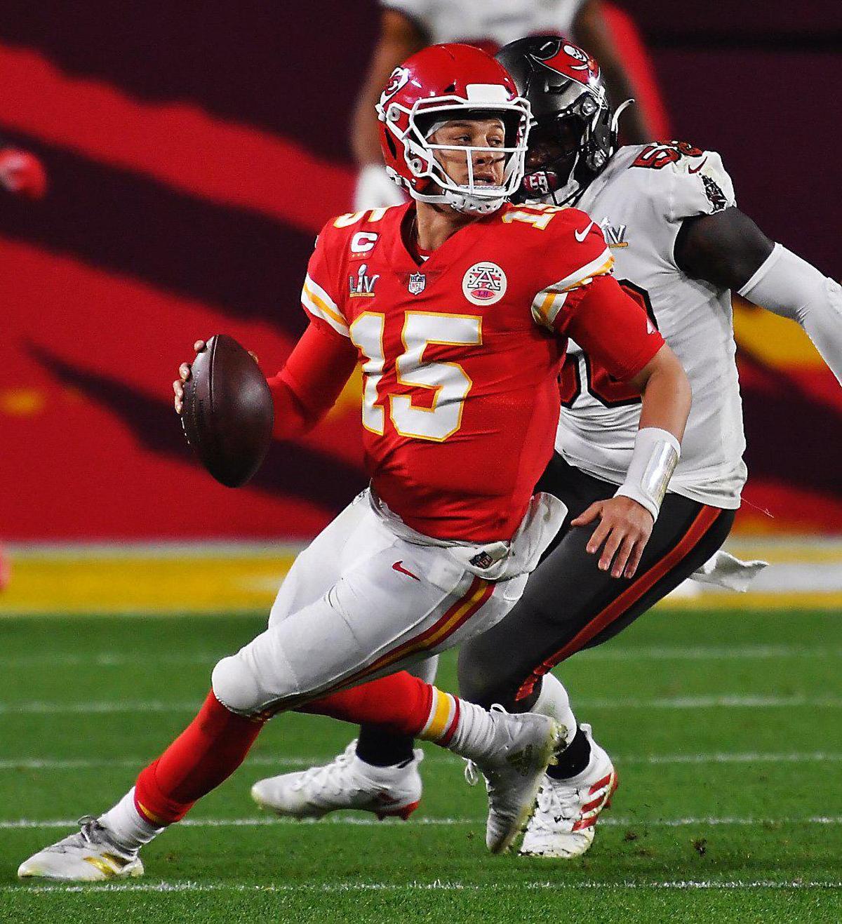 Kansas City Chiefs quarterback Patrick Mahomes attempts to get away from a Tampa Bay Buccaneers defender in the fourth quarter Sunday, February 7, 2021, at Super Bowl LV at Raymond James Stadium in Tampa, Florida.