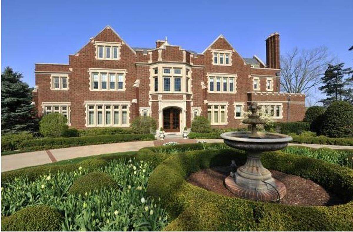 The home on Dunford Circle in Kansas City boasts plaster moldings, four fireplaces, carved wood paneling and a surrounding English garden.