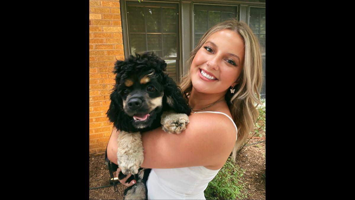 Lila Kubas with her cocker spaniel Indy in 2021, the year before she says she was sexually assaulted during a massage at a Kansas City salon.