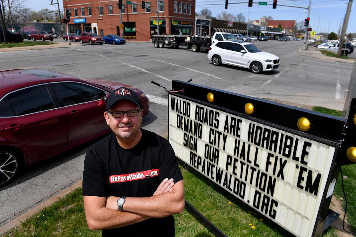 Frank Sereno is pictured with his mobile marquee sign at the intersection of 75th Street and Wornall Road. He encouraged passing motorists to sign his online petition demanding the city repair or resurface deteriorated streets in the Waldo neighborhood in Kansas City.