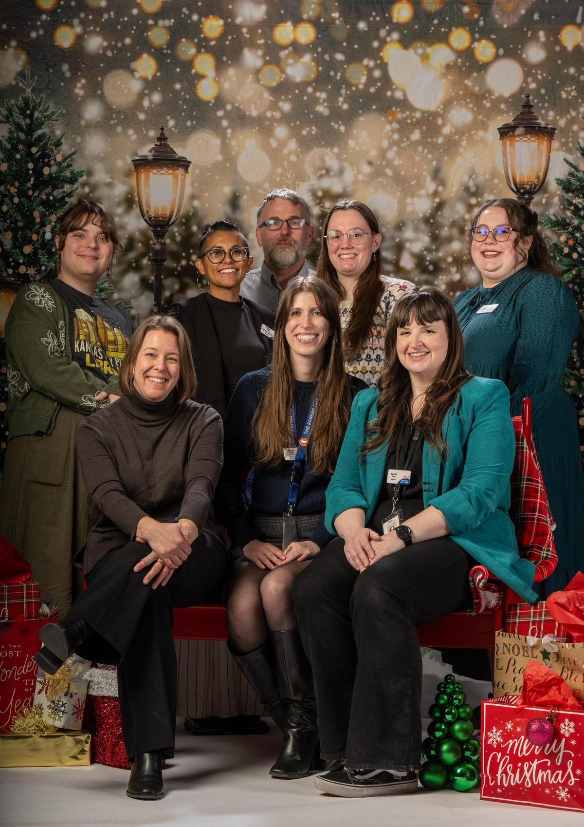 Kansas City Public librarians (back) Sophie Williams, Ruby Jones, Steven Woolfolk, Alisha Helms, Lucy Donnelly, (front) Anne Kniggendorf, Anna Bernard, and Leslie Case on Thursday, Dec. 12, 2024, at the Plaza Branch Library.