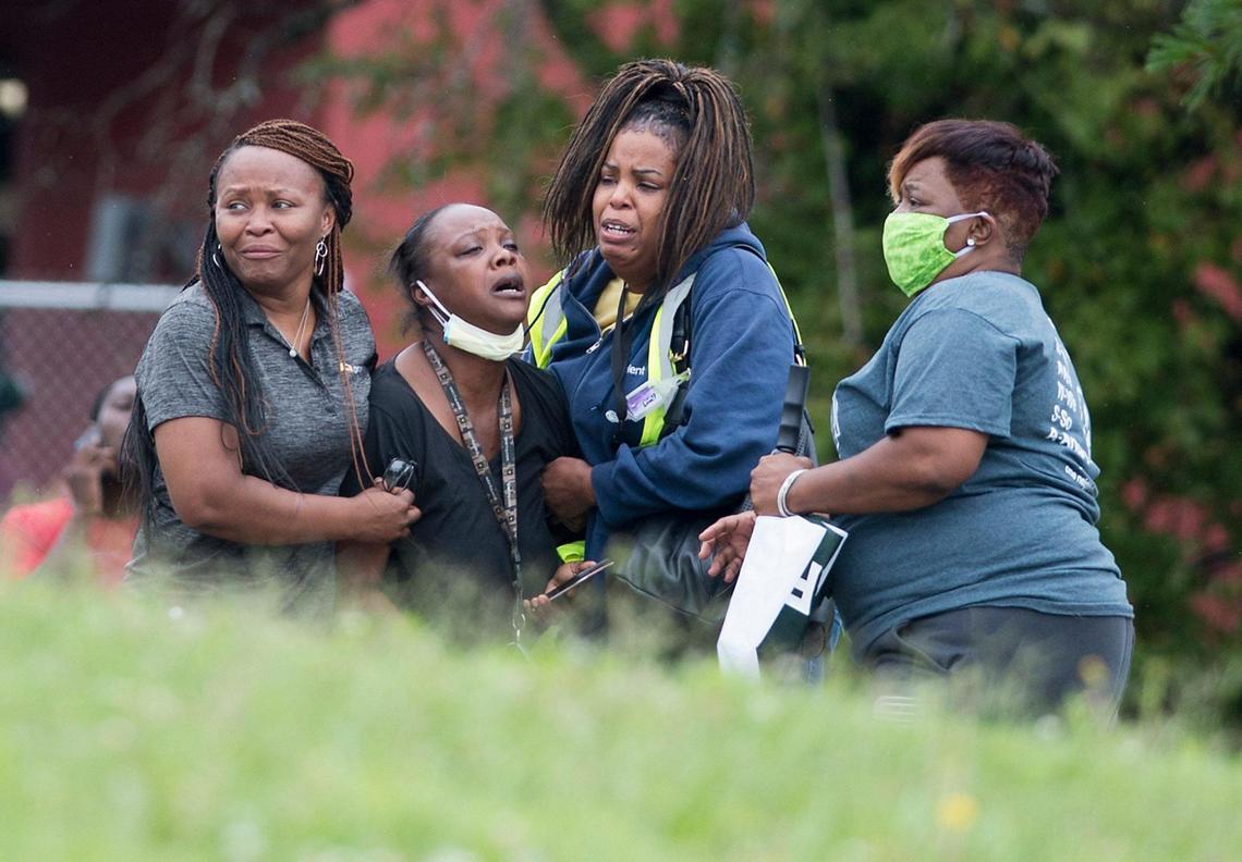 Family and friends gathered and grieved across from a convenience store after a woman who had been pushing a baby in a stroller was fatally shot Monday in the 2600 block of Van Brunt Boulevard in Kansas City, according to police. The baby, who was reported to at a local hospital, was unharmed. Rosilyn Temple of Mothers’ in Charge (right) was on hand to offer her support to the family.