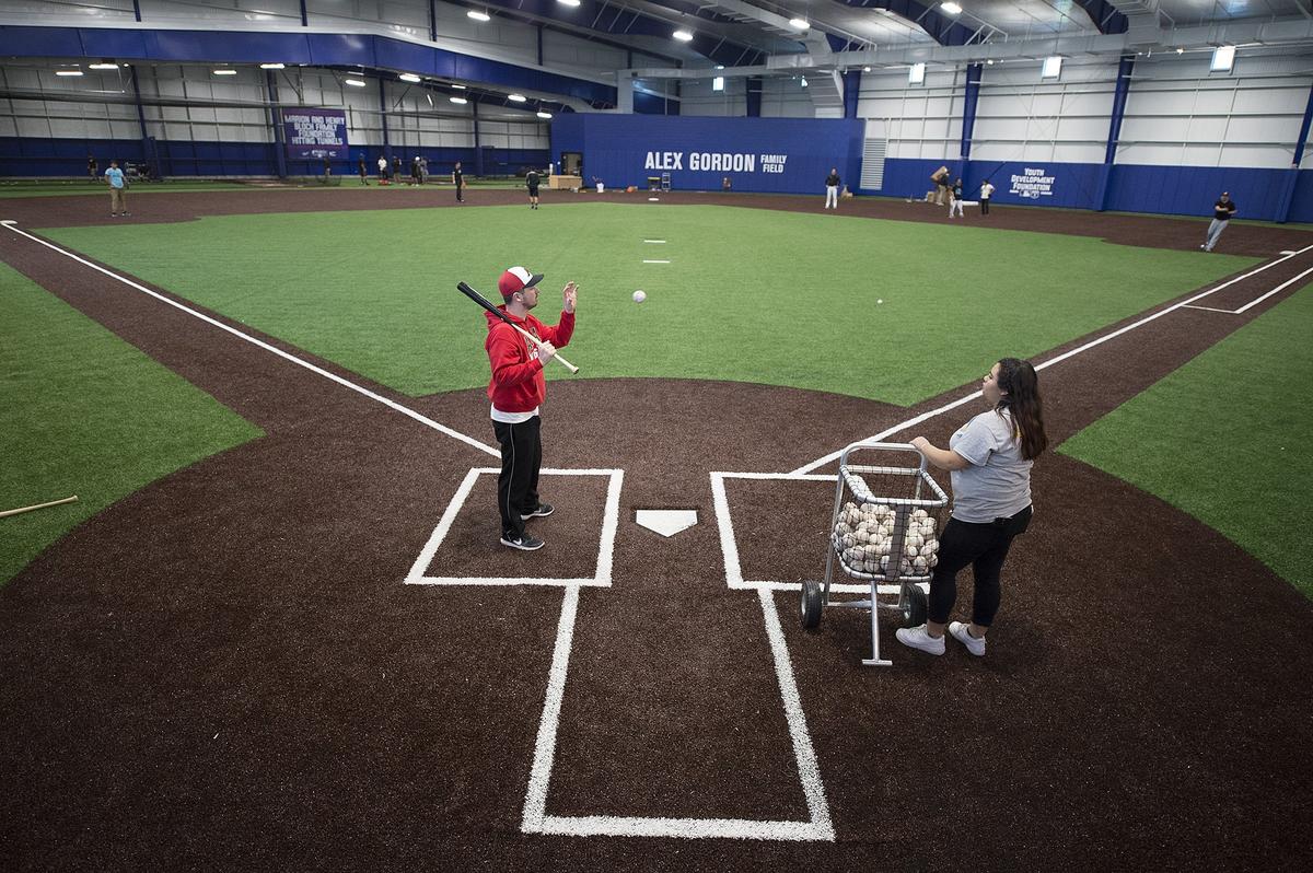 When the weather is bad, members of the Alta Vista High School baseball team practice indoors on the Alex Gordon Family Field at the Urban Youth Academy.