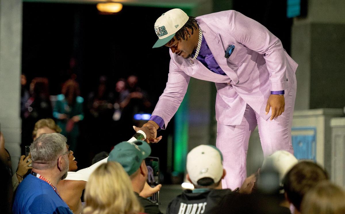 Georgia defensive lineman Jalen Carter celebrates with fans after being picked ninth overall by the Philadelphia Eagles during the NFL Draft outside of Union Station on Thursday, April 27, 2023, in Kansas City.