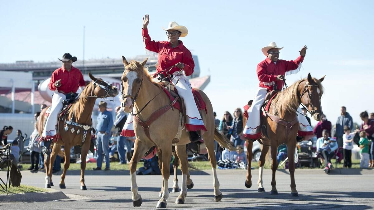 Members of the Show Me Riders, a local saddle club, waved to the crowd during the American Royal parade Saturday, Oct. 3, 2015  at Arrowhead Stadium in Kansas City. The parade, which featured "A Star Spangled Salute" was moved to the Truman Sports Complex this year to be held during the American Royal's World Series of Barbecue. 