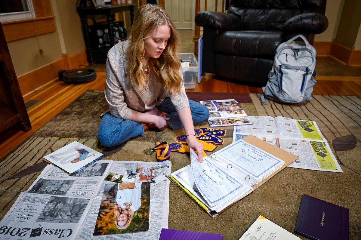 Haylee Weissenbach, 20, looks over her achievements from when she was one of the valedictorians in the Class of 2019 at McLouth High School in McLouth, Kansas.