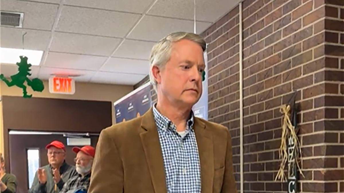 Kansas Sen. Roger Marshall walks out of a town hall in Oakley as the crowd boos on March 1, 2025.