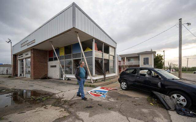 Randy McCurdy, owner of McCurdy's Auto Sales & Auto Service, looked over damage on Tuesday, April 14, 2026, in Ottawa, Kansas, after a tornado moved through the town Monday night.