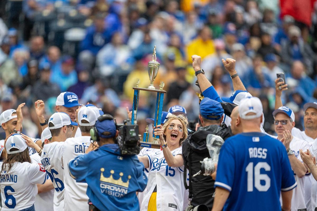 Actress Heidi Gardner hoists a trophy after winning the softball tournament during the Big Slick celebrity softball game at Kauffman Stadium on Friday, May 31, 2024, in Kansas City.