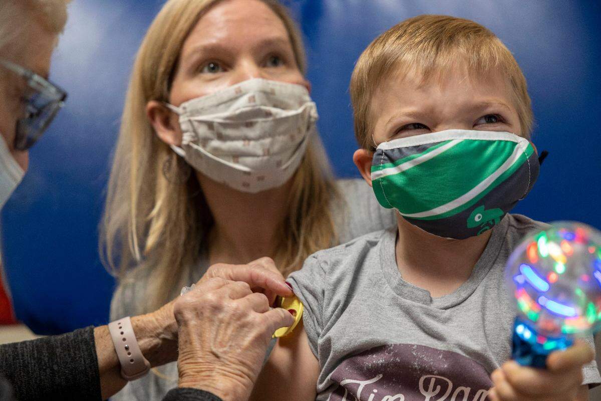 Sarah Edwards holds her son, Anderson, for his first dose of the COVID-19 vaccine at Children’s Mercy Hospital Kansas in Overland Park, one of the first area vaccine clinics for kids 5 to 11.