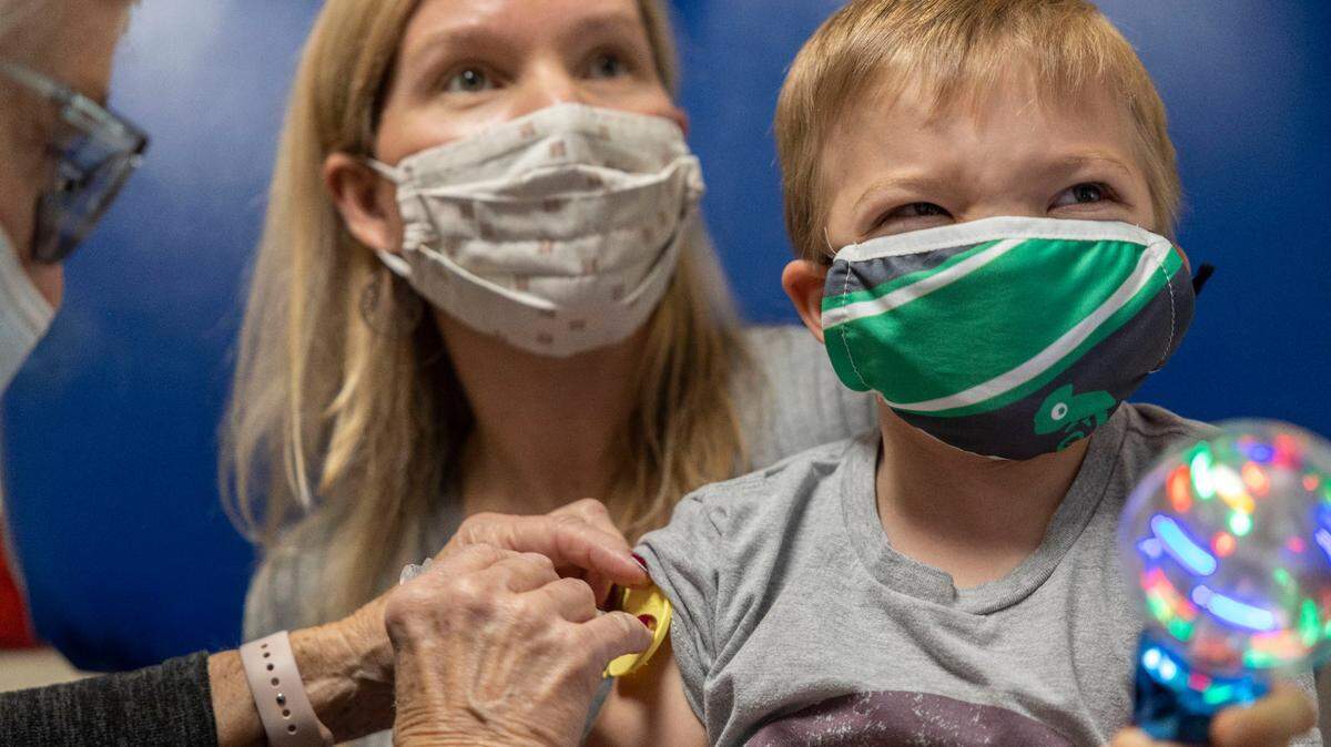 Sarah Edwards holds her son, Anderson, for his first dose of the COVID-19 vaccine at Children’s Mercy Hospital Kansas in Overland Park, one of the first area vaccine clinics for kids 5 to 11.