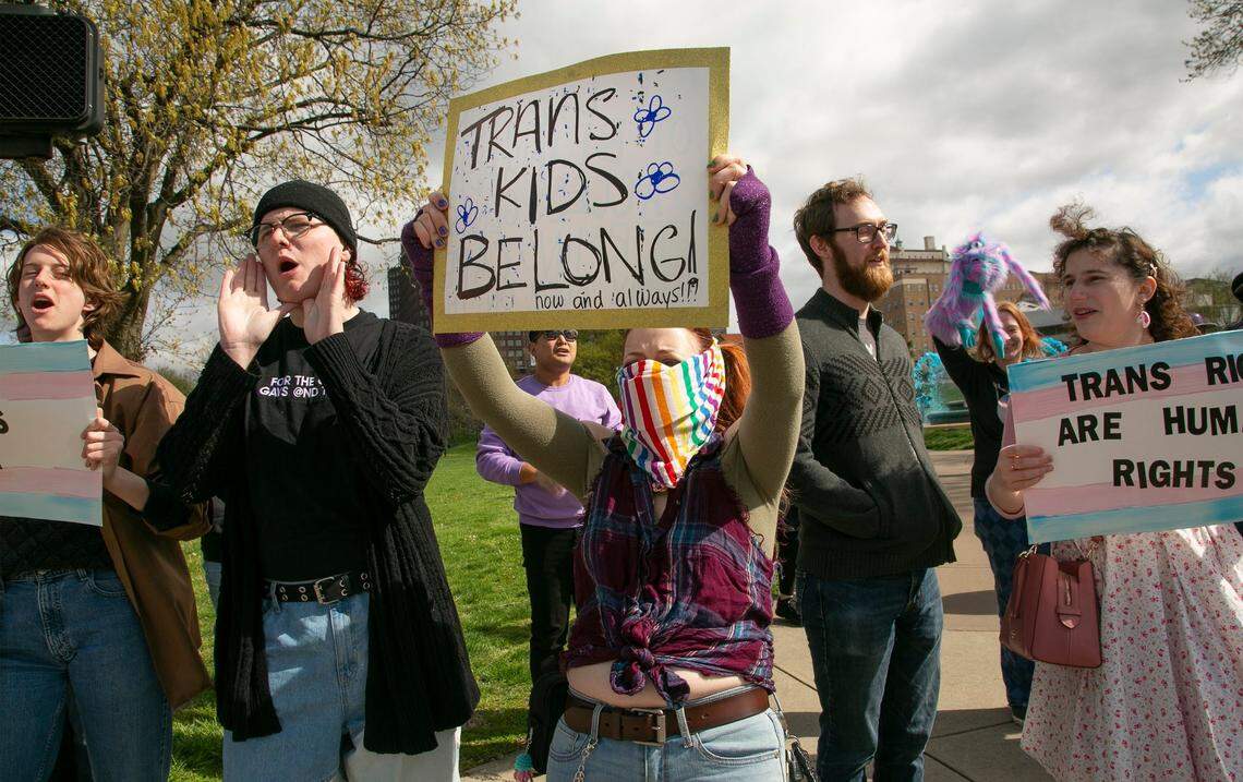 Andi McMillan (center) joined transgender friends, family and other supporters of LGBTQ rights on April 16 at Mill Creek Park near the Country Club Plaza to protest Attorney General Andrew Bailey’s proposed restrictions on trans care.