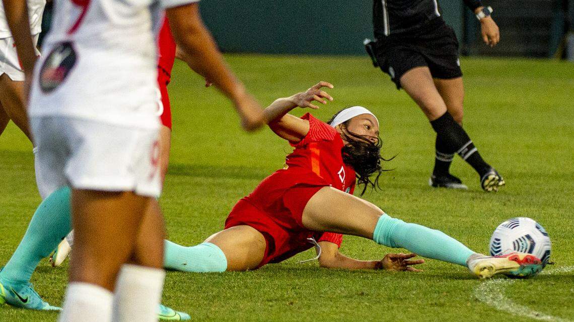 Kansas City midfielder Victoria Pickett kicks the ball forward after being tripped during a play in the game against Washington Spirit, Saturday, June 26, 2021, at Legends Field in Kansas City, Kan. Kansas City lost the game 1-2.