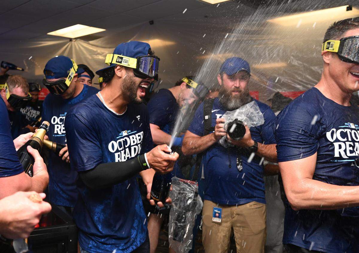 Kansas City Royals players celebrate in the locker room after defeating the Baltimore Orioles in Game 2 of the Wild Card round at Oriole Park at Camden Yards on Oct. 2, 2024.