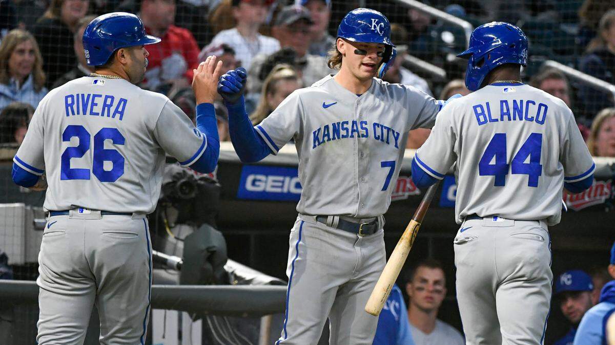 Kansas City Royals’ Emmanuel Rivera (26) and Dairon Blanco (44) celebrate with Bobby Witt (7) after Rivera and Blanco scored on a double by Whit Merrifield off Minnesota Twins pitcher Tyler Duffey during the eighth inning of a baseball game Thursday, May 26, 2022, in Minneapolis. The Royals won 3-2. (AP Photo/Craig Lassig)