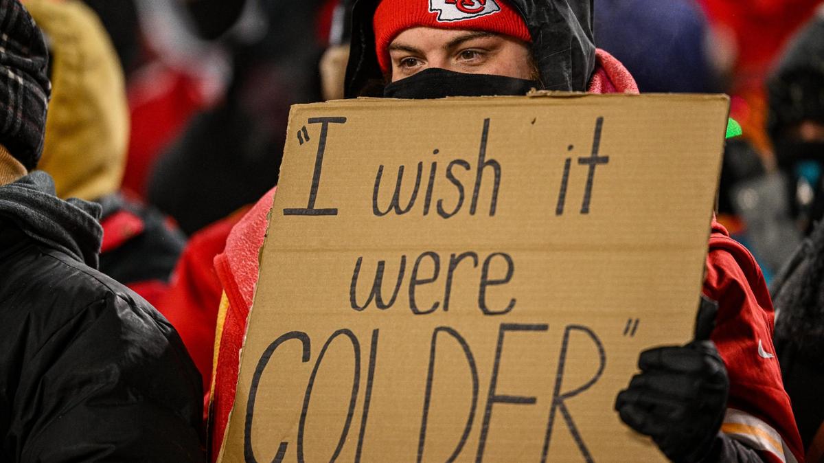 A Kansas City Chiefs fan holds a sign about the cold weather on Jan. 13, 2024, at GEHA Field at Arrowhead Stadium.