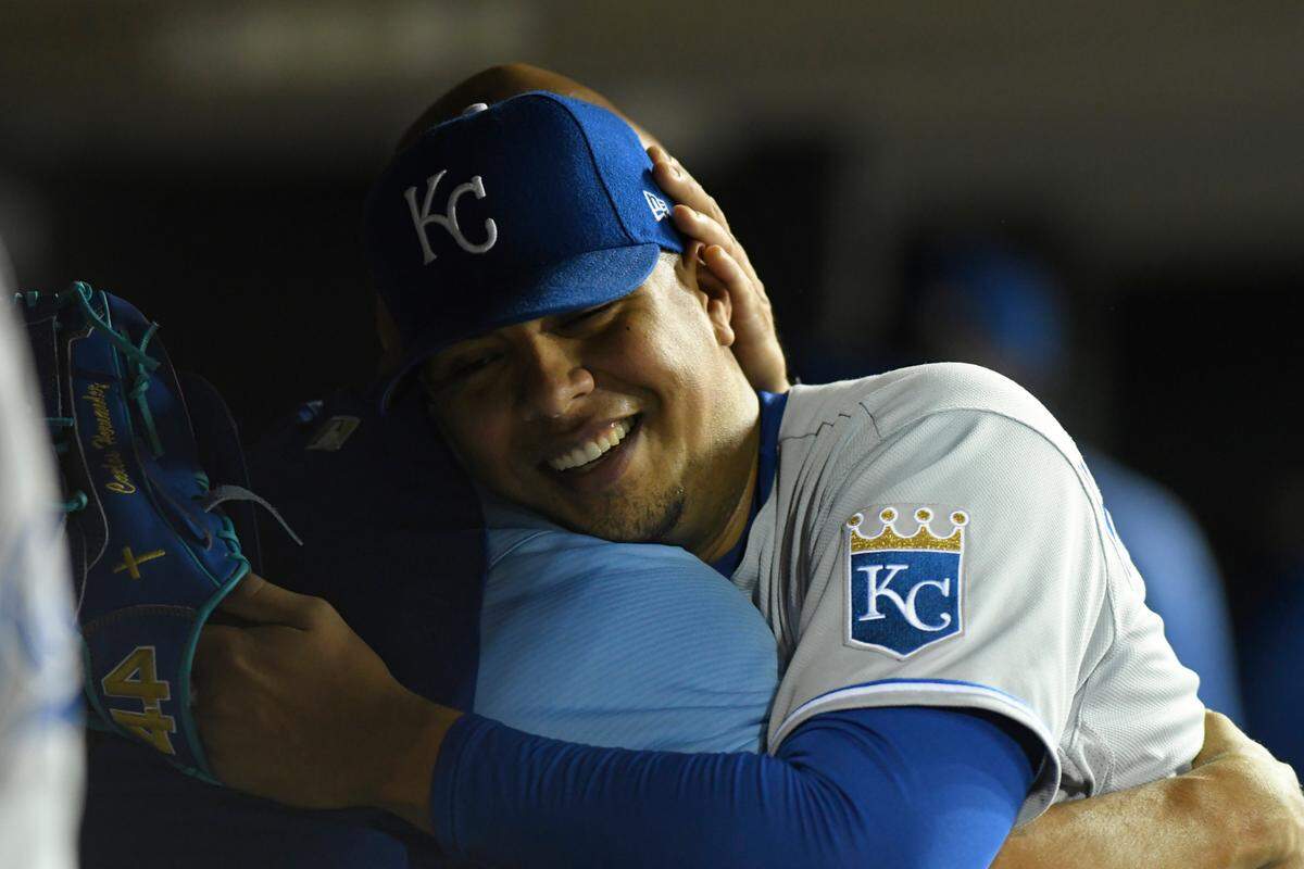 Kansas City Royals starting pitcher Carlos Hernandez is hugged by teammates after getting the final out in the fifth inning of a baseball game against the Detroit Tigers, Friday, Sept. 24, 2021, in Detroit. (AP Photo/Jose Juarez)
