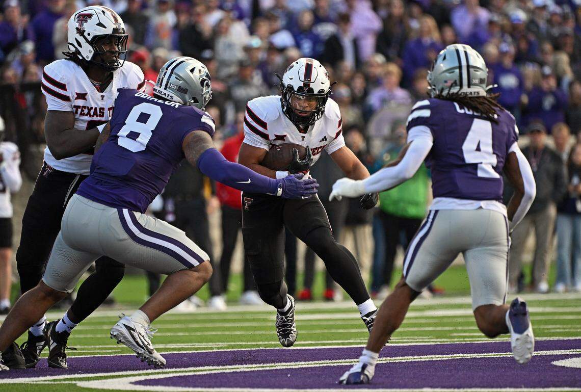 MANHATTAN, KS - NOVEMBER 01: Running back Cameron Dickey #8 of the Texas Tech Red Raiders runs upfield against defensive end Chiddi Obiazor #8 and safety Daniel Cobbs #4 of the Kansas State Wildcats in the first half at Bill Snyder Family Football Stadium on November 1, 2025 in Manhattan, Kansas. (Photo by Peter Aiken/Getty Images)