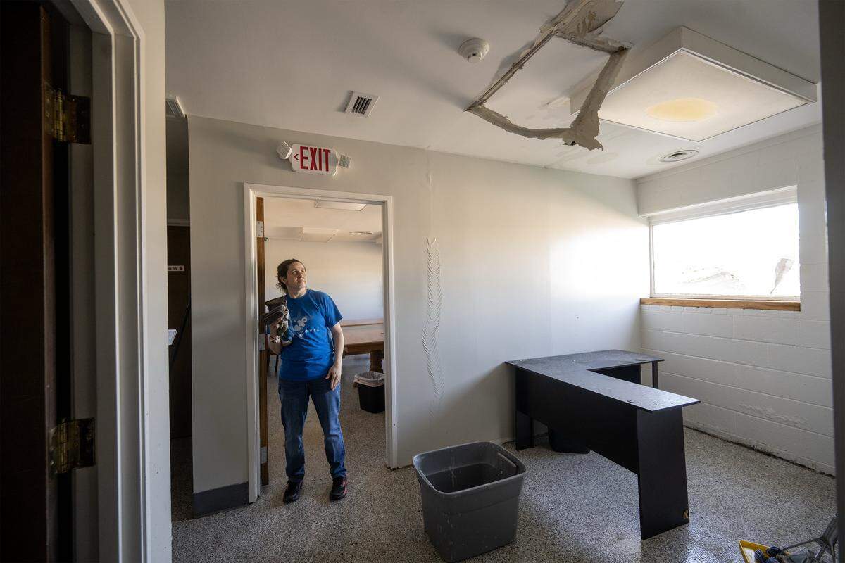 Tiffany Wyatt, co-director of the Hope House, a not-for profit food pantry, looks over interior damage on Tuesday, April 14, 2026, one day after a tornado hit the organization in Ottawa, Kansas.
