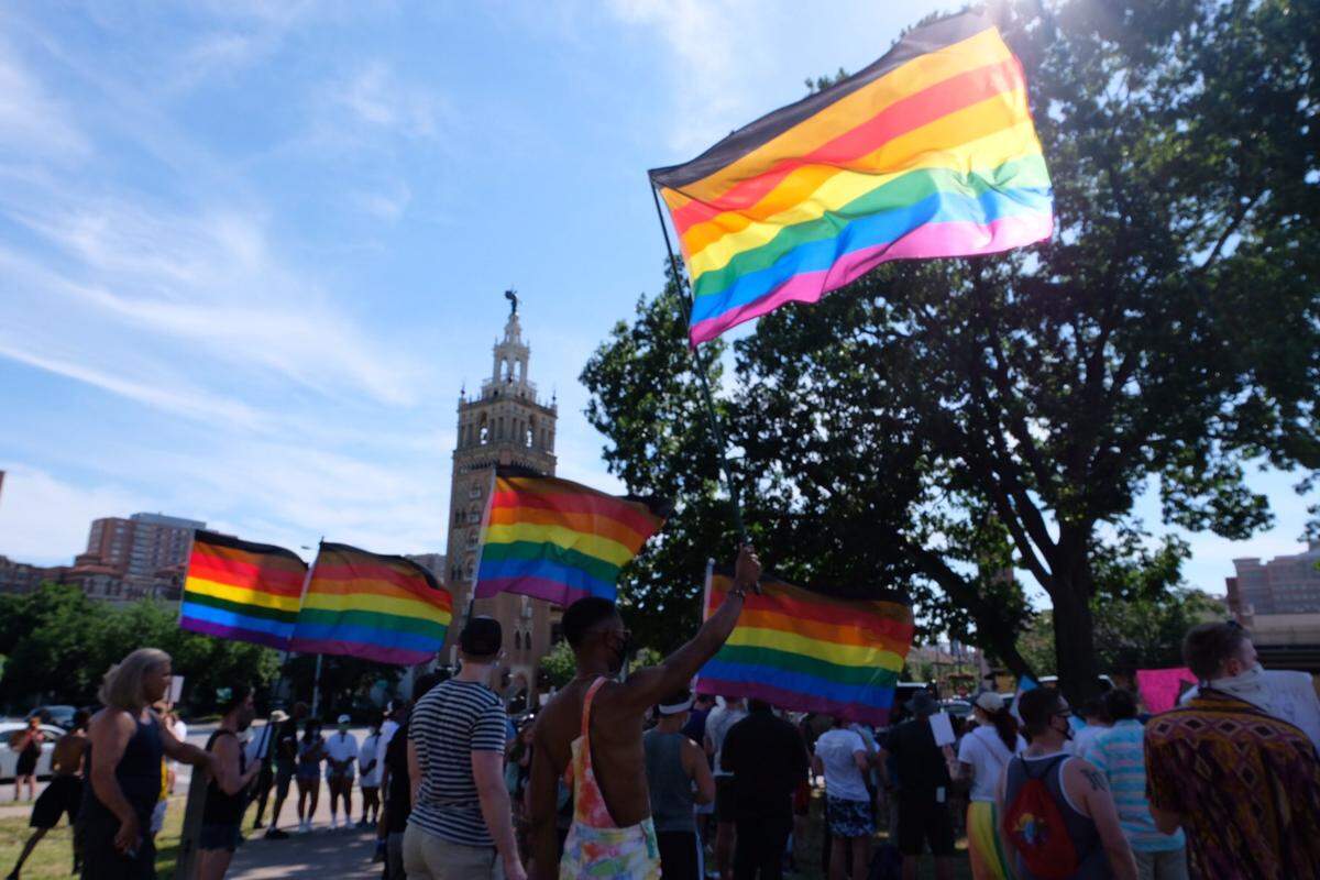 At a protest by the County Club Plaza on June 6, several protesters carried Pride flags.