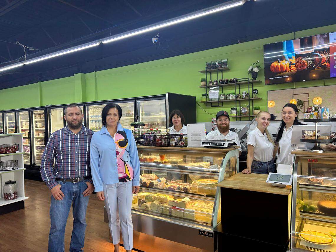 Volodymyr and Iuliia Polishchuk, left, with four of their employees, each of them refugees from Ukraine.