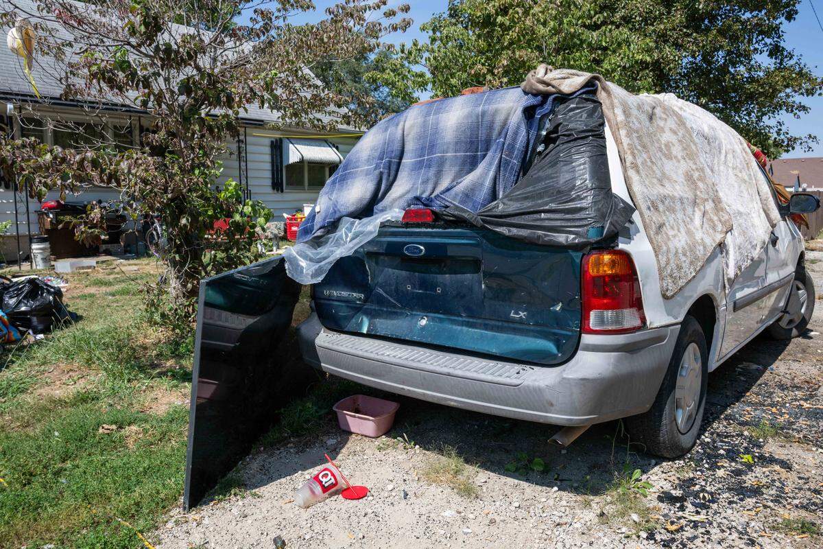 A ransacked minivan sits in the front yard of Timothy Friese's home, in Kansas City, on Thursday, Sep. 11, 2025. Squatters have transformed most of Timothy Friese's home, interior and exterior, into a homeless encampment and Friese is facing fines of up to $100 a day from the city.