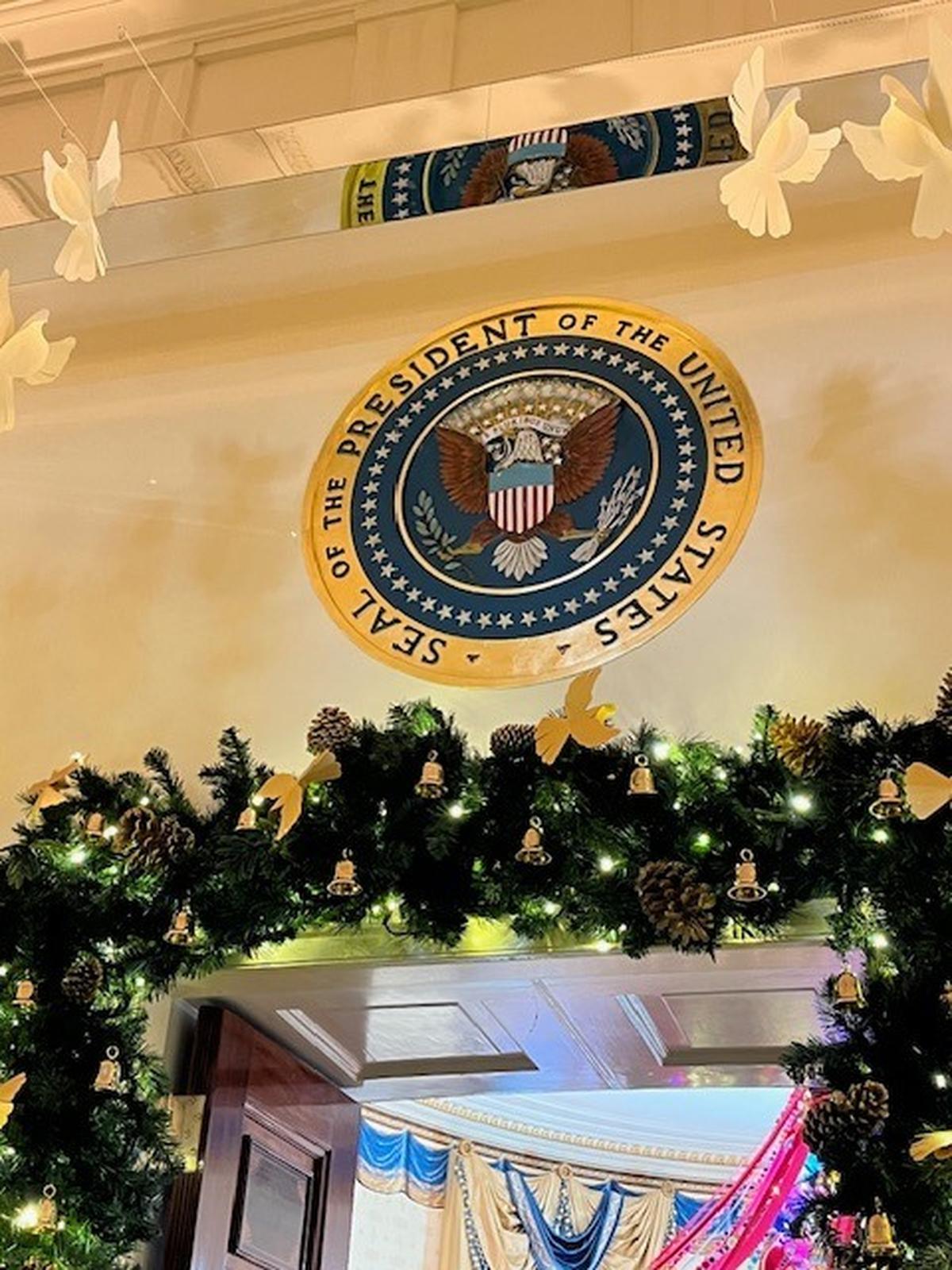 The Presidential Seal over a White House doorway.