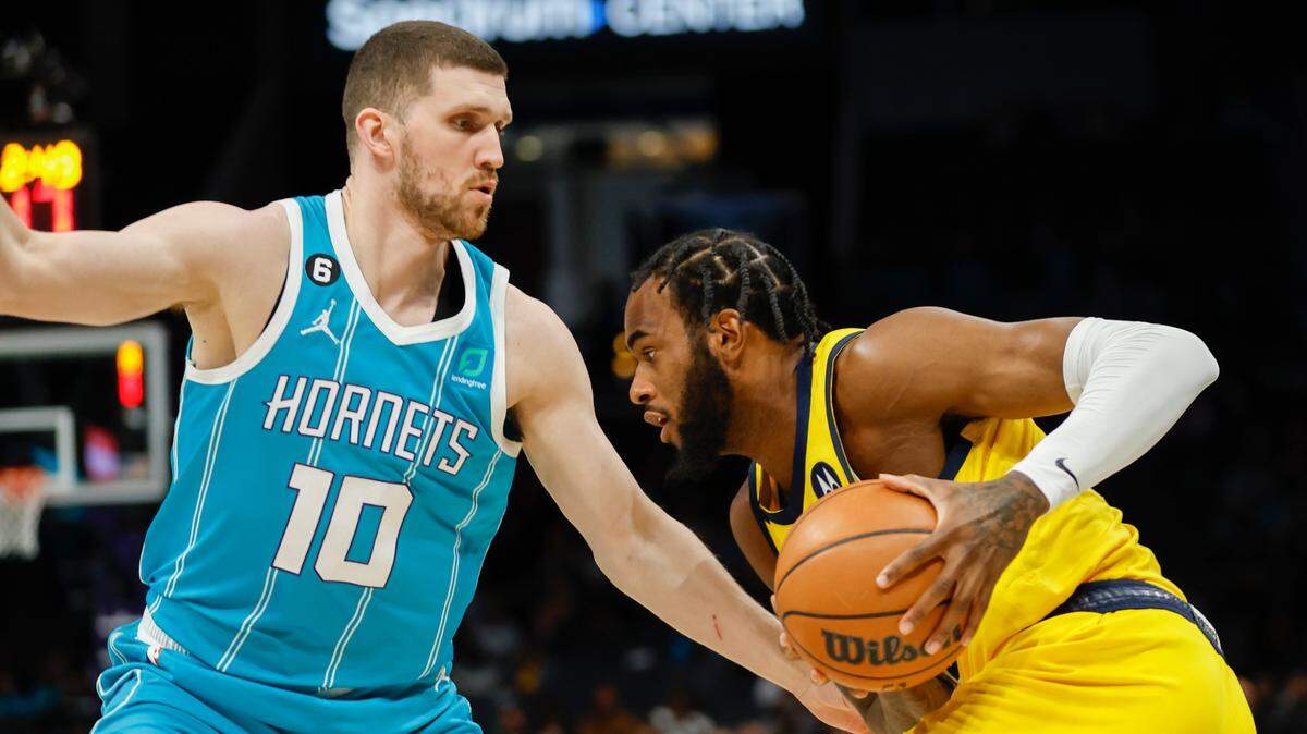 Indiana Pacers forward Oshae Brissett (12) drives against Charlotte Hornets guard Svi Mykhailiuk (10) during the first half at Spectrum Center in Charlotte, North Carolina, on March 20, 2023.