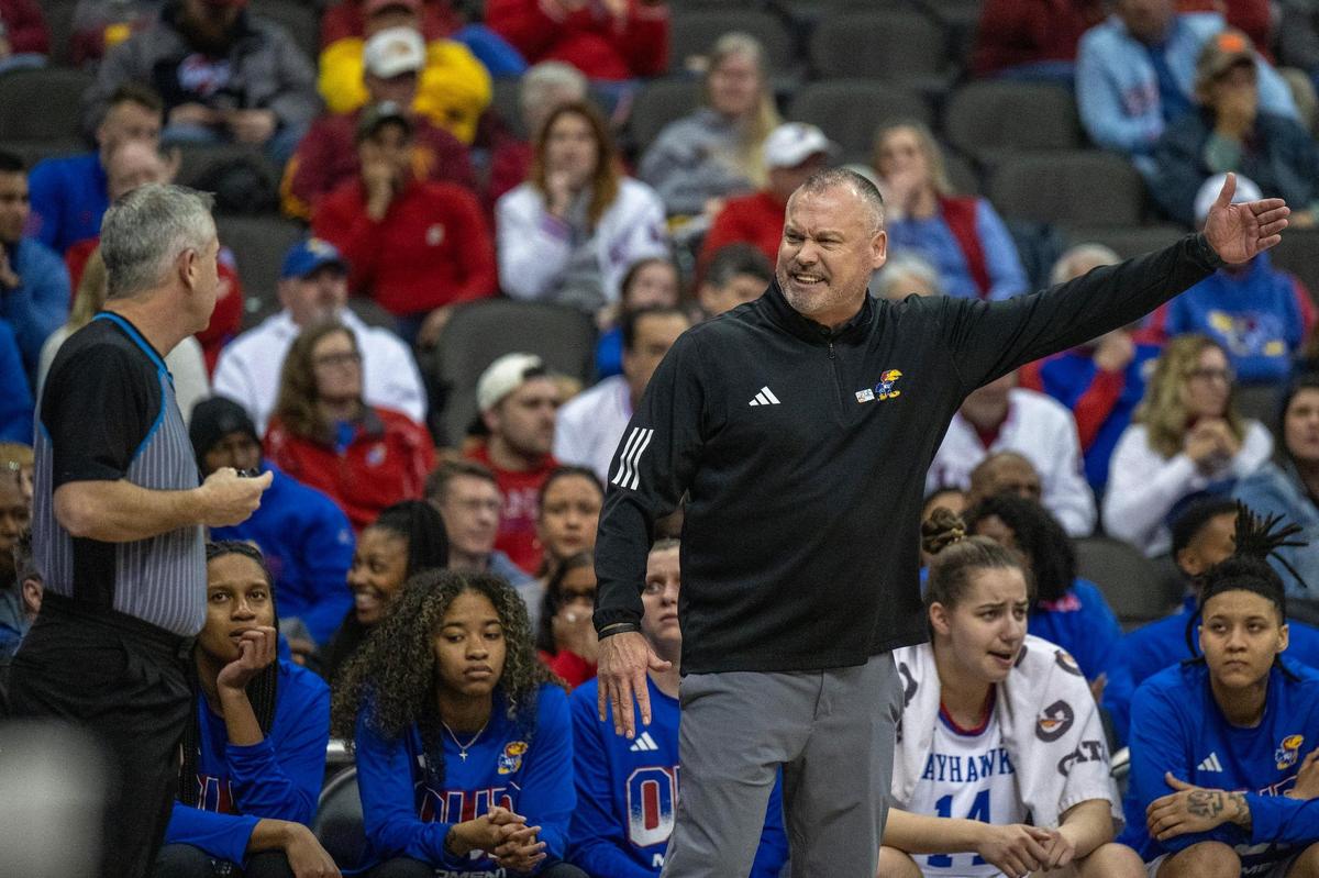 Kansas Jayhawks head coach Brandon Schneider disputes a call with a referee in the first half of a Big 12 Tournament women’s basketball game against the BYU Cougars at T-Mobile Center on Friday, March 8, 2024, in Kansas City.