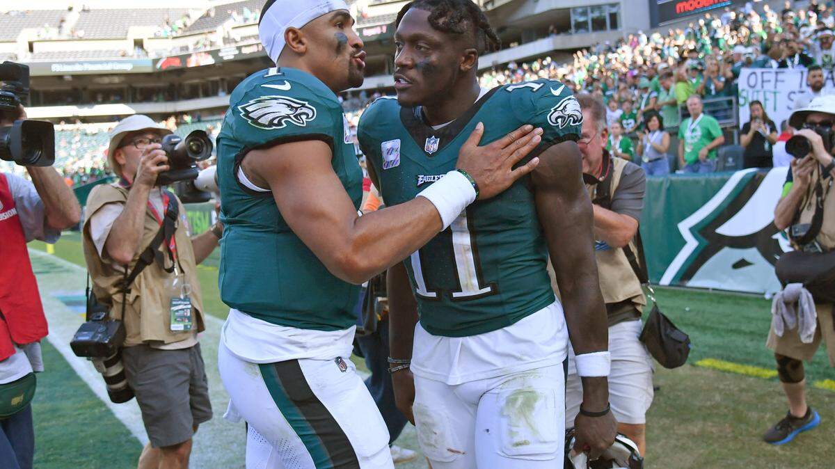 Philadelphia Eagles quarterback Jalen Hurts (1) and wide receiver A.J. Brown (11) walk off the field against the Washington Commanders at Lincoln Financial Field.