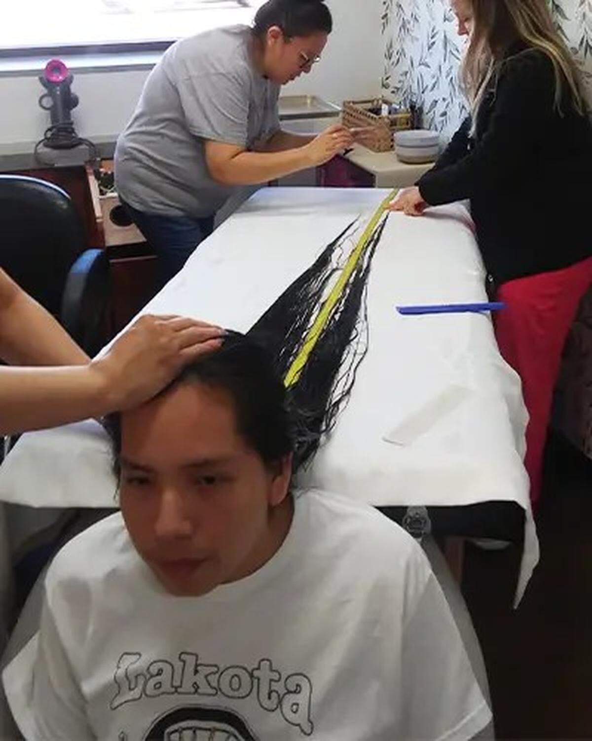 The teen’s hair was washed, brushed and laid out on a table to measure.